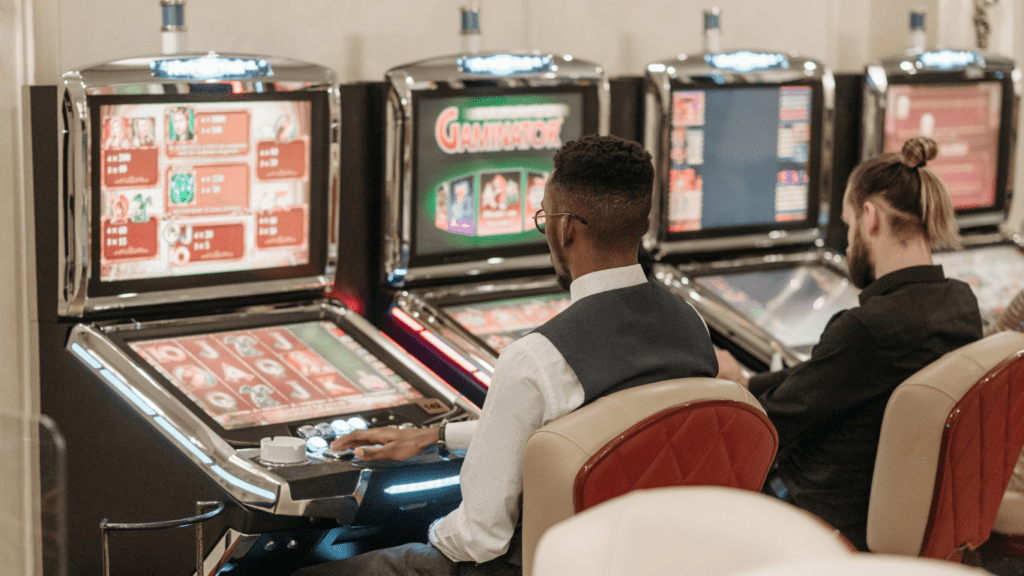 Men playing slot machine