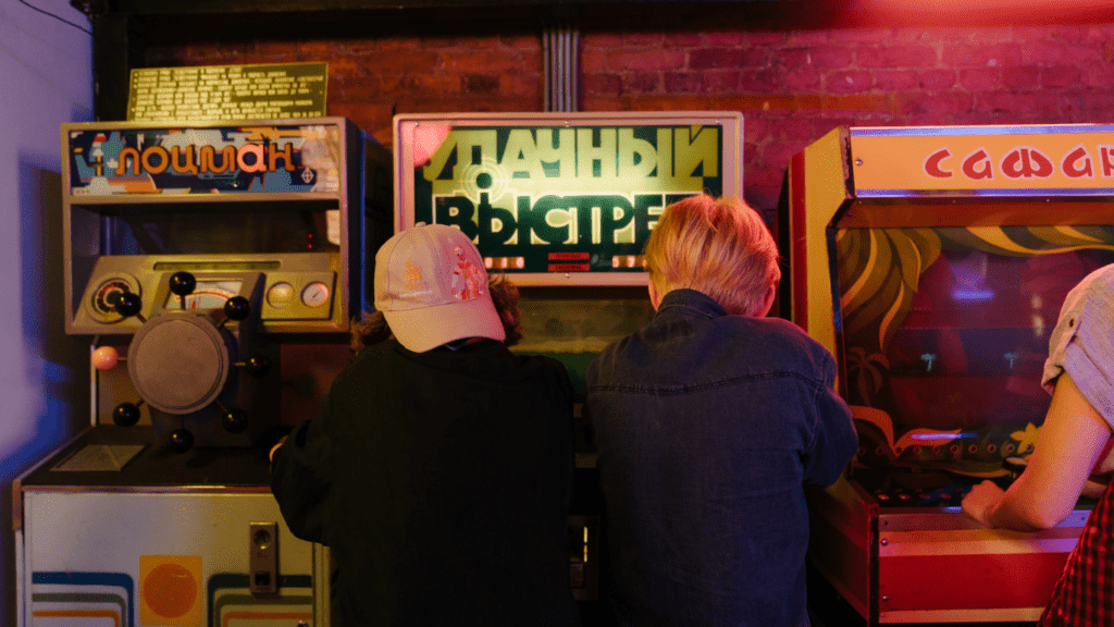 two guys playing slot machine