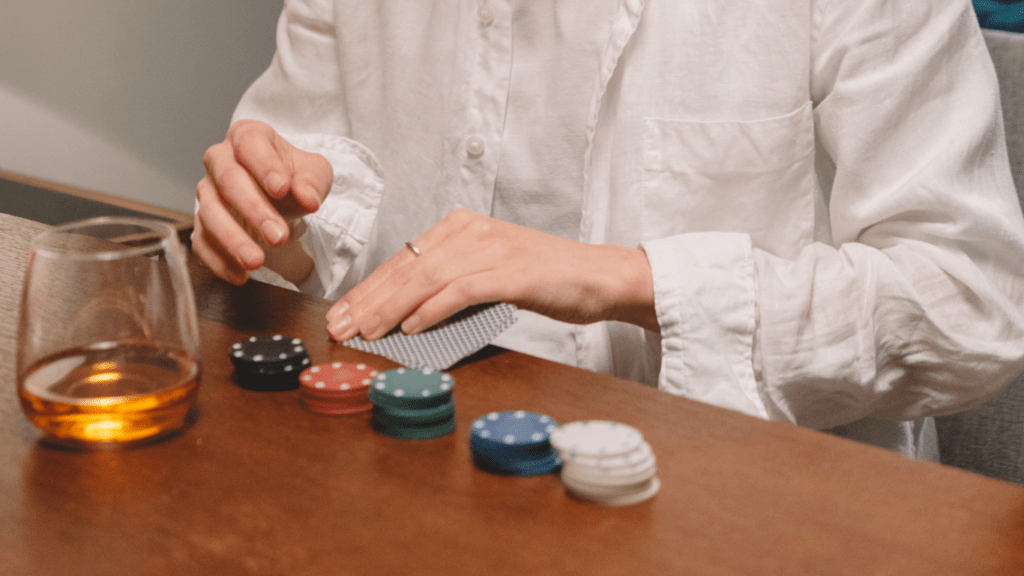 woman playing poker while drinking