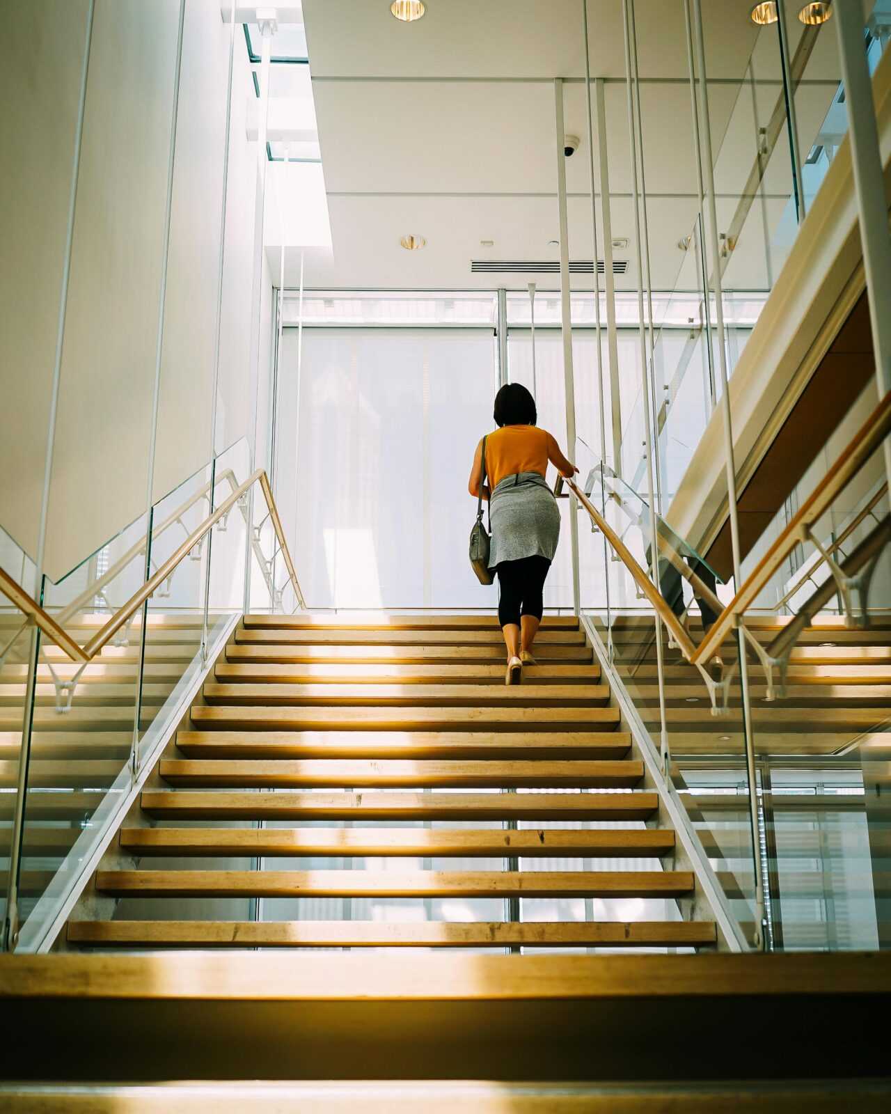 Woman Walking on Brown Stair